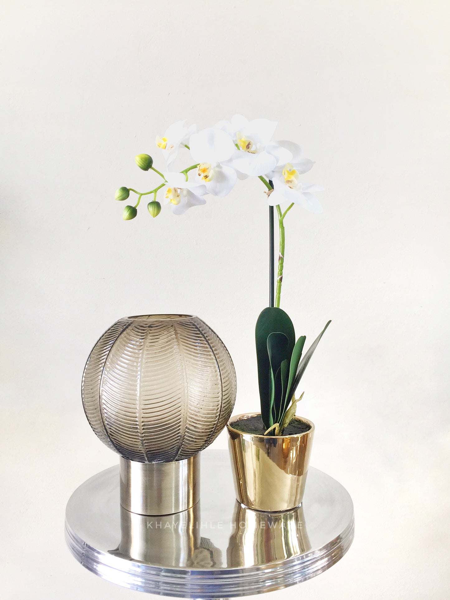 Artifical orchid in gold pot