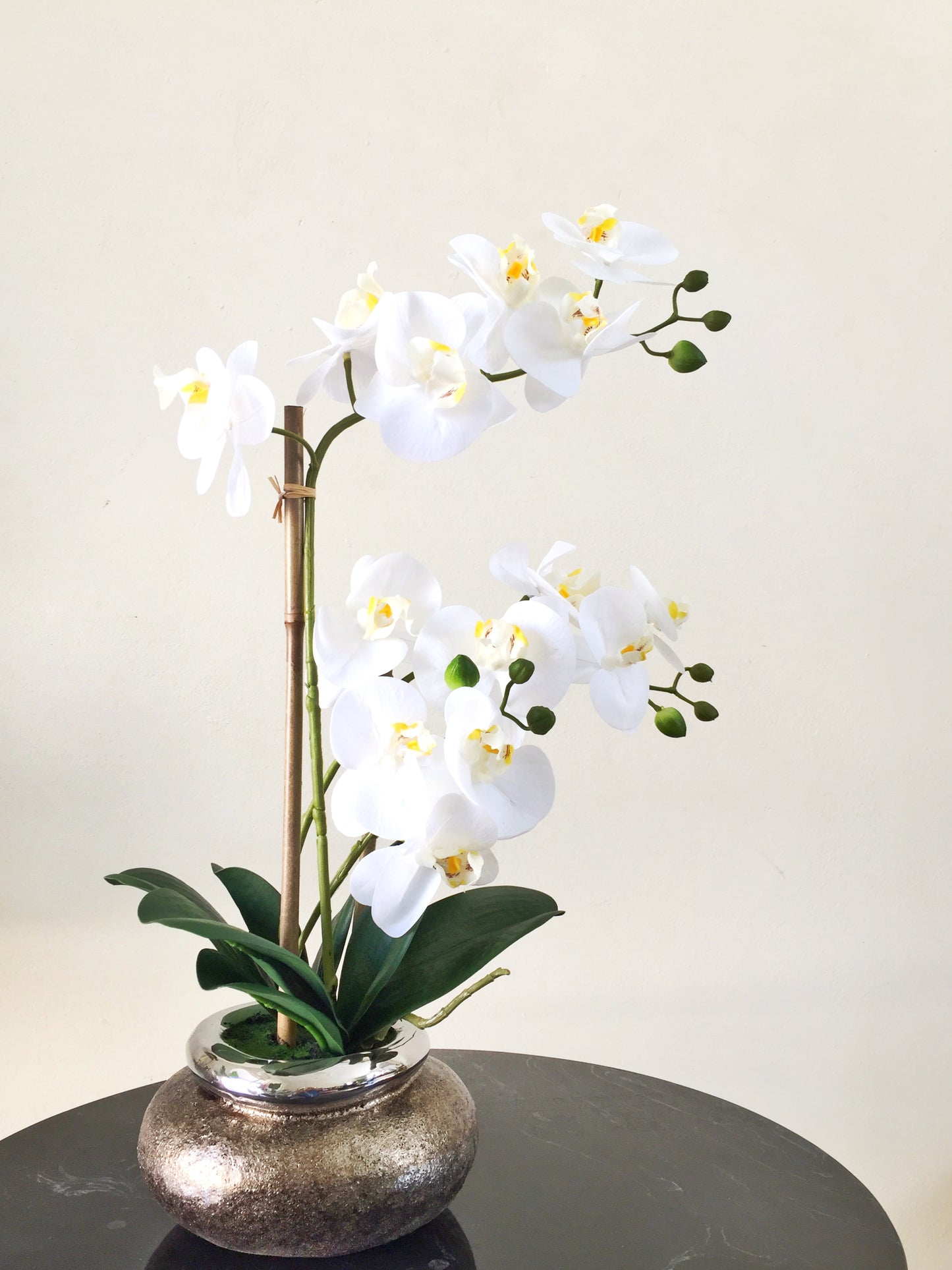 Artificial white orchid in copper pot