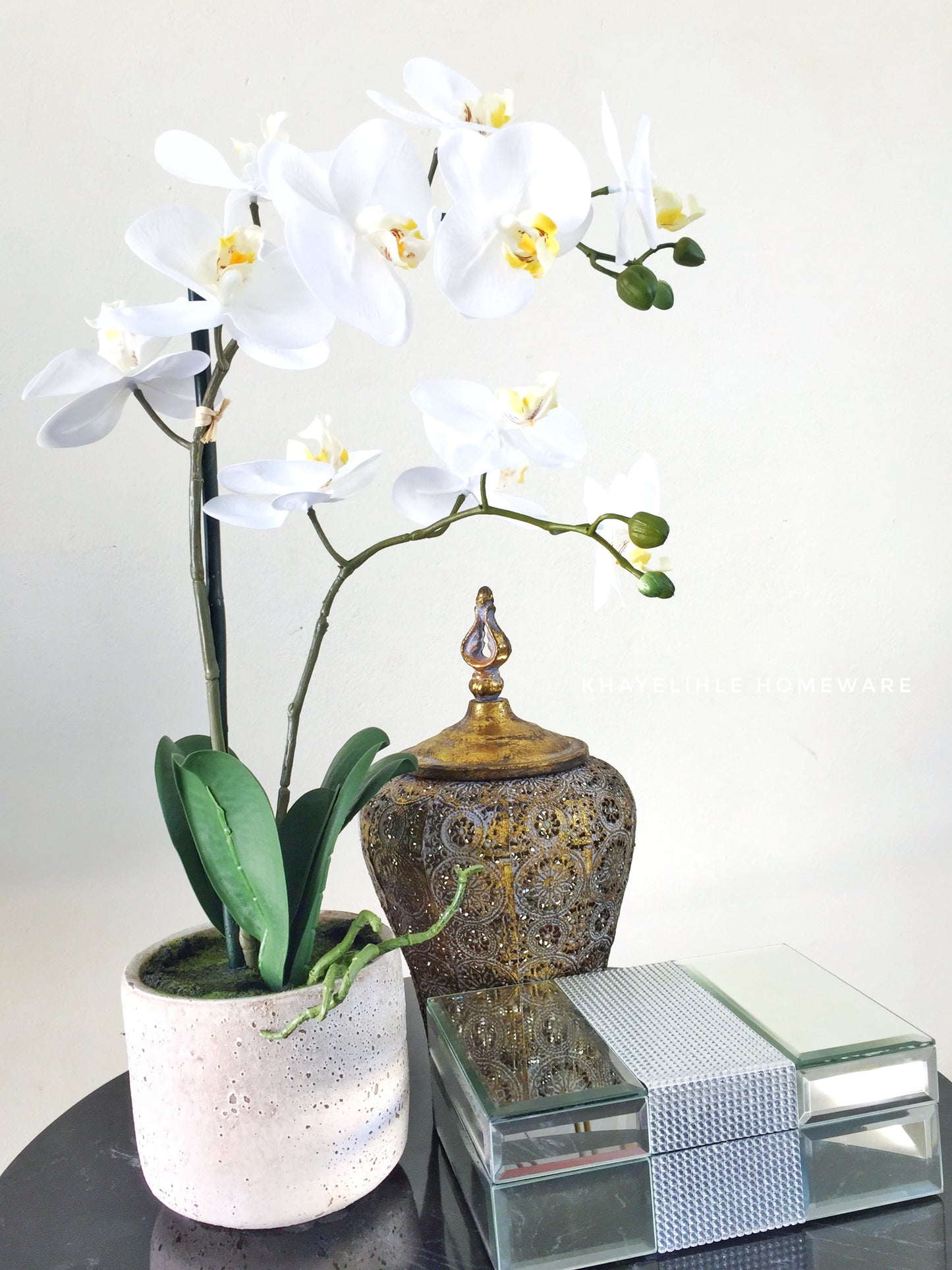 Artificial white orchid in cement pot
